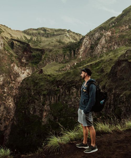 Adventurous backpacker exploring mountainous terrain in Southeast Asia