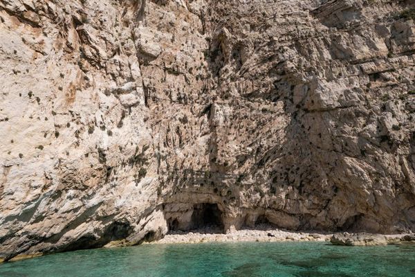 Crystal clear turquoise lagoon surrounded by dramatic limestone cliffs
