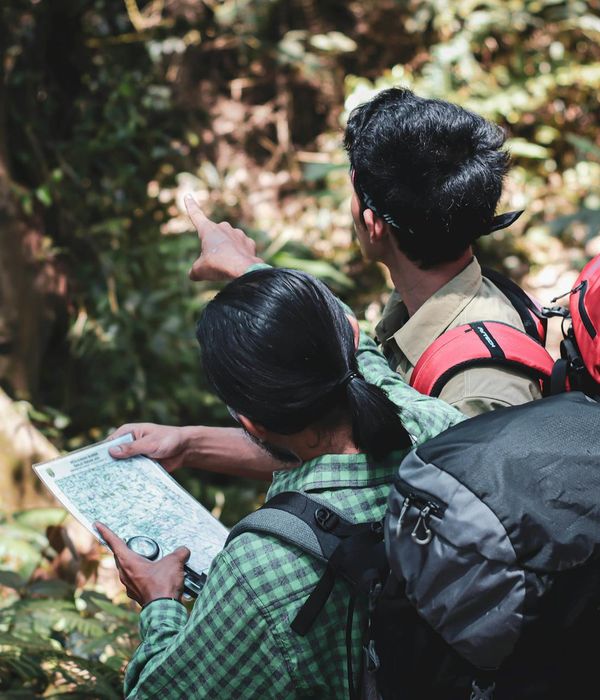 Dedicated team of backpackers collaborating on travel route planning