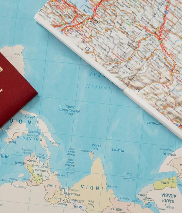 Traveler planning personalized route with maps and guidebooks